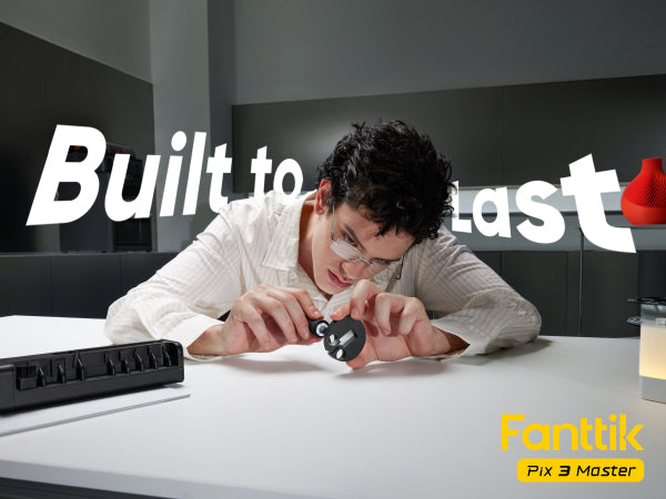 A man is shown closely examining a small product using Fanttik Pix 3 Master Electric Detail Sander with large text reading 'Built to last' in the background and a small yellow 'With Pix 3 Master' mark in the lower right corner.