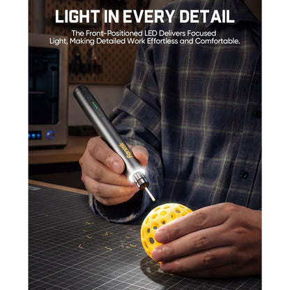 Person using a Fanttik F2 Master Kit Cordless Rotary Tool with a light on a workbench, emphasizing detailed work.