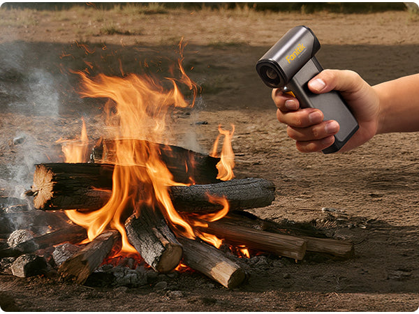 Hand holding aFanttik B10 Pro Max Electric Air Duster to blow a campfire