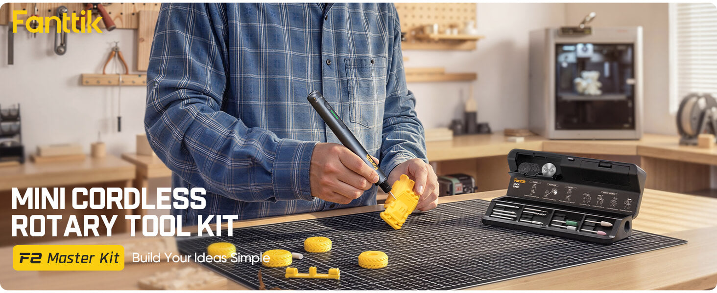 Person using a Fanttik F2 Master Kit Cordless Rotary Tool in a workshop setting.