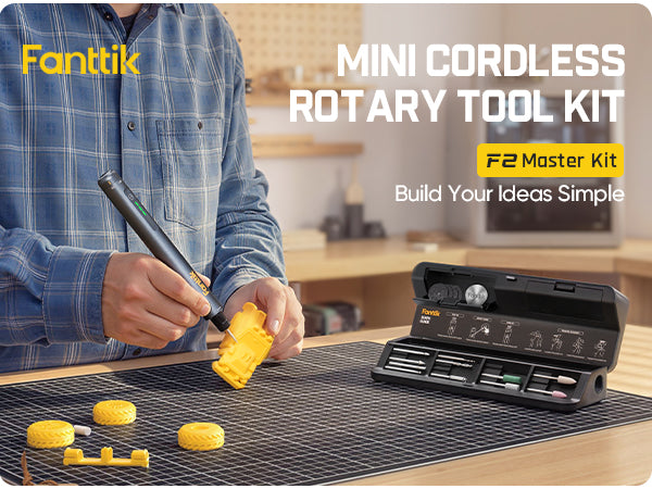 Person using a Fanttik F2 Master Kit Cordless Rotary Tool in a workshop setting.
