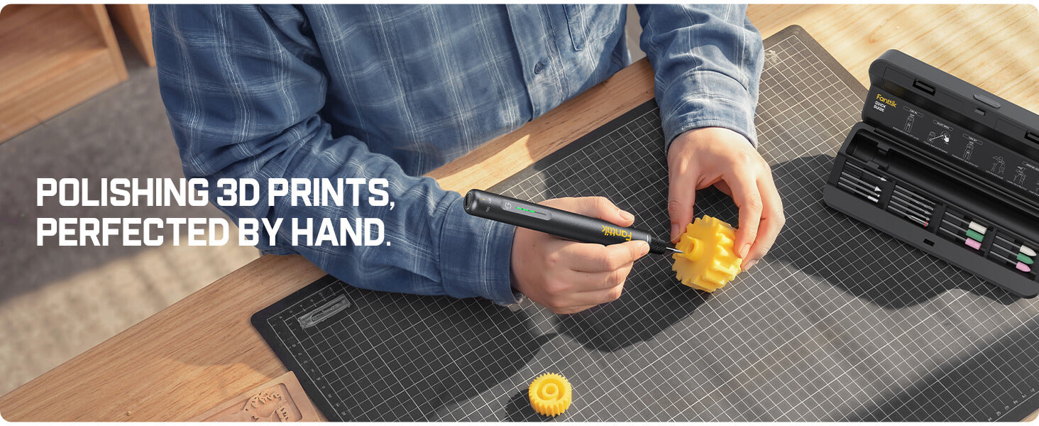 Person polishing 3D prints with a Fanttik F2 Master Kit Cordless Rotary Tool on a workbench, text 'Polishing 3D prints. Perfected by hand.'
